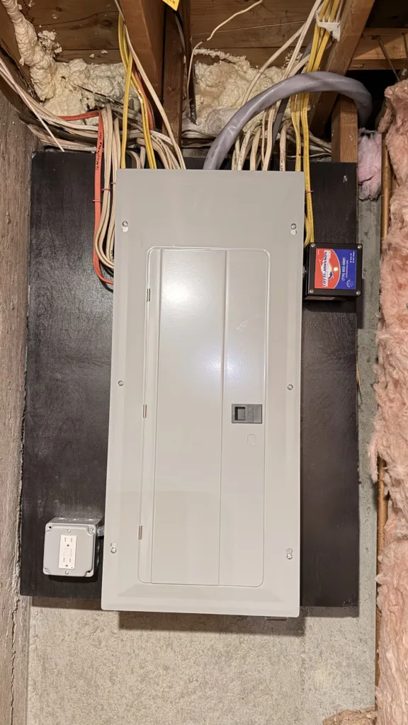 The completed electrical service change, highlighting the newly installed, fully enclosed, and cleanly mounted electrical panel.